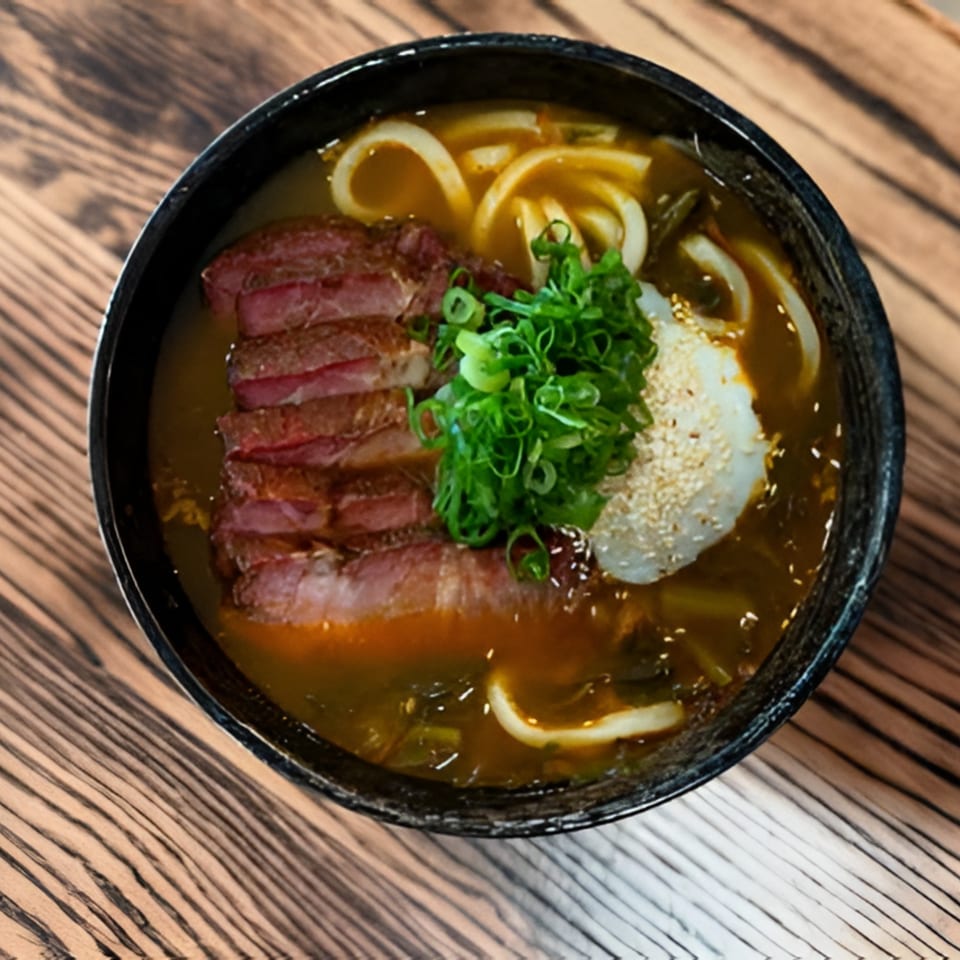Bar Bushido's Japanese ramen with sliced beef, green onions, and a poached egg.