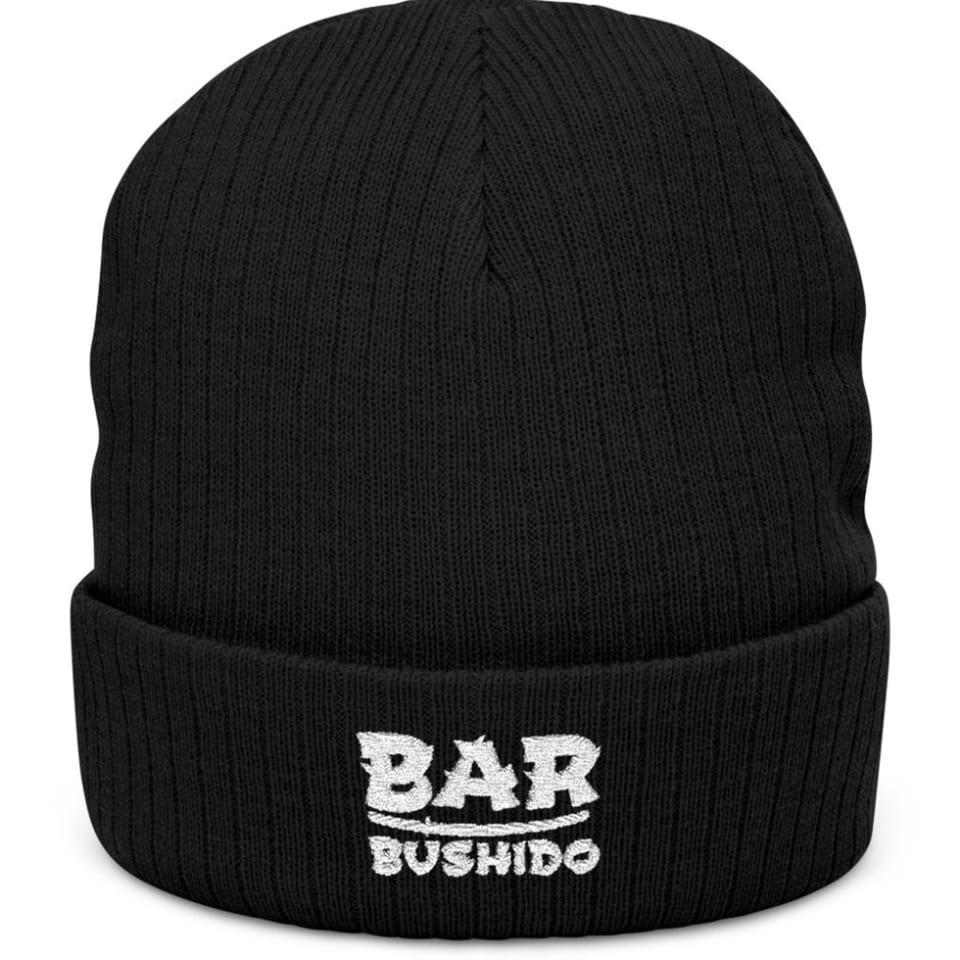 Black knit beanie with "BAR BUSHIDO" embroidered in white on the folded brim.